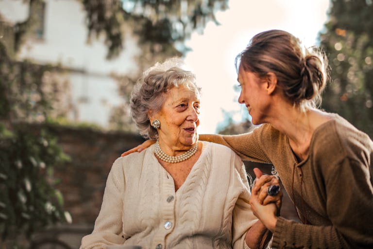 Adult child and aging parent in warm, honest conversation at home
